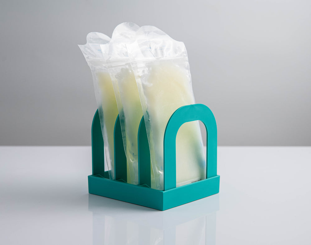 Mylk Mate holding three frozen breast milk bags upright