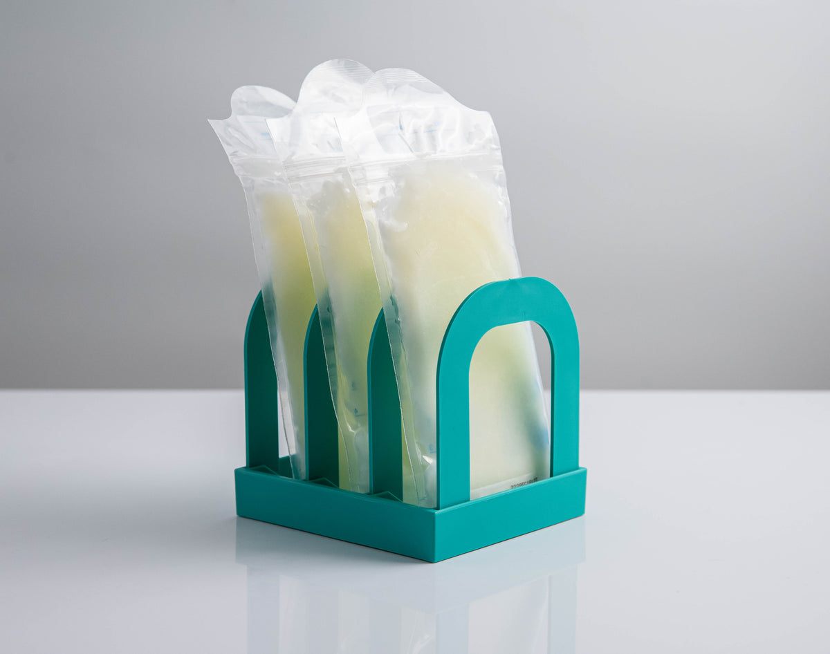 Front view of Mylk Mate holding three frozen breast milk bags upright in its three slots
